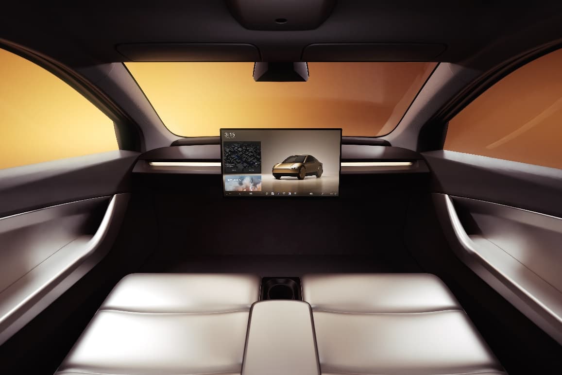 The back seat of a car with a monitor
Description automatically generated